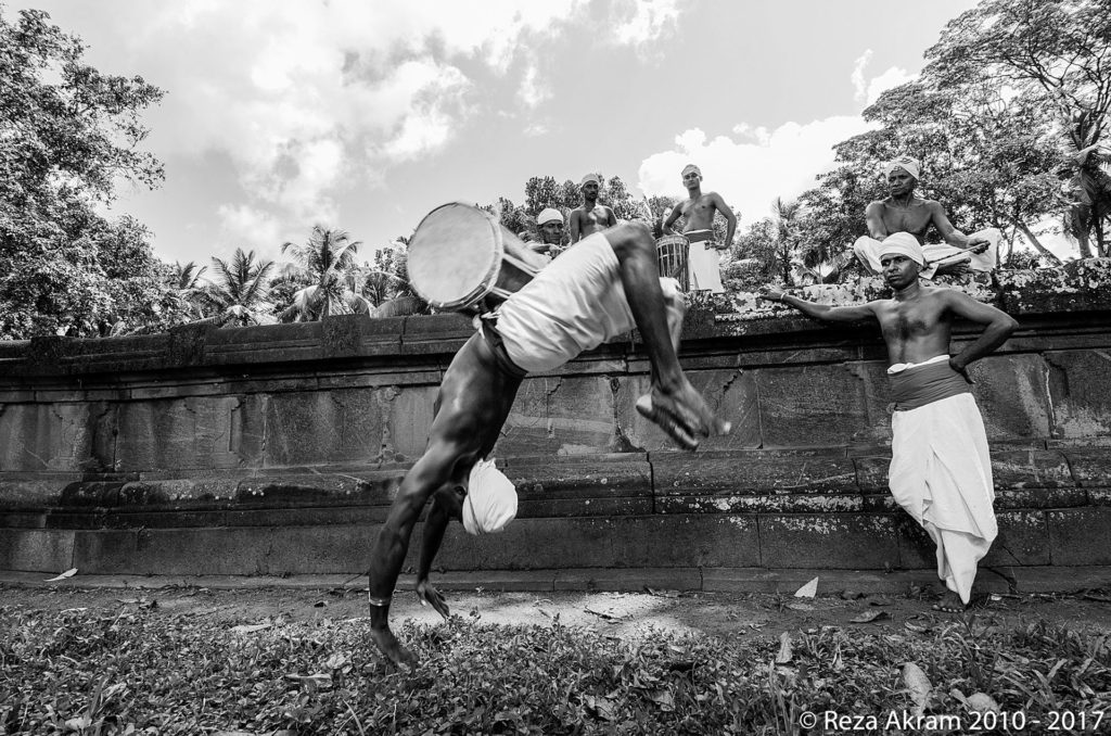 After the banning, Angampora movements and techniques assimilated into other traditional Sri Lankan arts such as dancing and drumming. Pictured is a drummer performing a backflip; a movement influenced by Angampora. © Reza Akram 2010 - 2017
